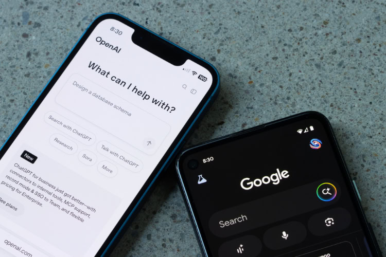 Zwei Smartphones nebeneinander, eines mit geöffneter OpenAI-App und ChatGPT-Oberfläche, das andere mit der Google-Suchseite im Dunkelmodus.