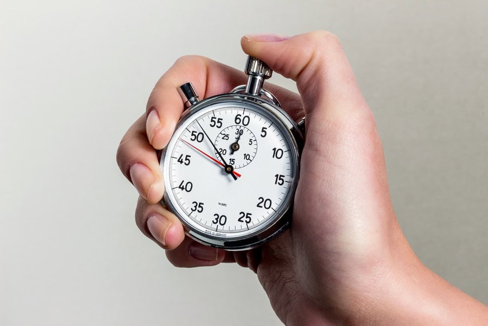 Eine Hand hält eine Stoppuhr.
