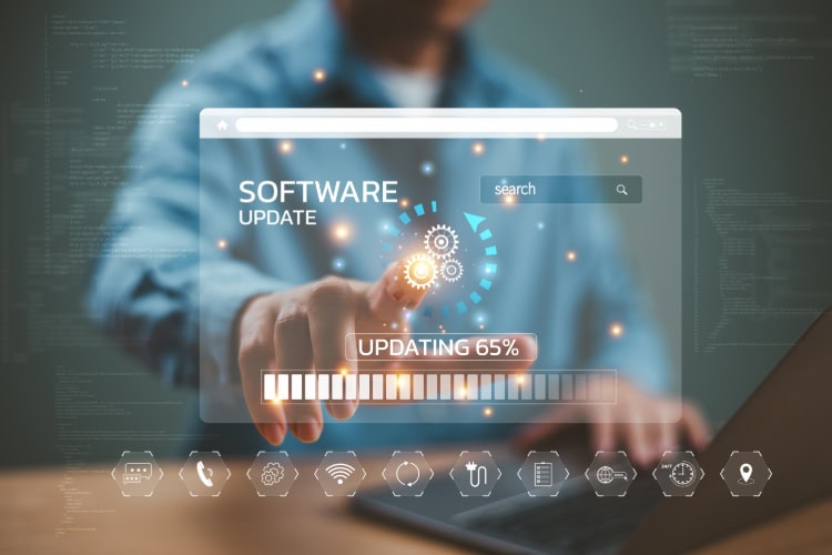 Ein Mann arbeitet an einem Laptop, tippt mit dem Finger auf ein symbolisches Software-Update.